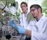 Environmental Biology research scientists setting up experiments with a microbial fuel cell