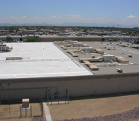 Visual comparison of a cool roof treatment (left) with a standard commercial rooftop