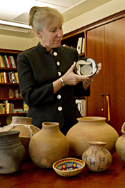 Dr. Nelson admires a classic Mimbres black-on-white pot of the 11th century style