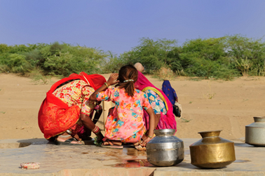Children around water source, India